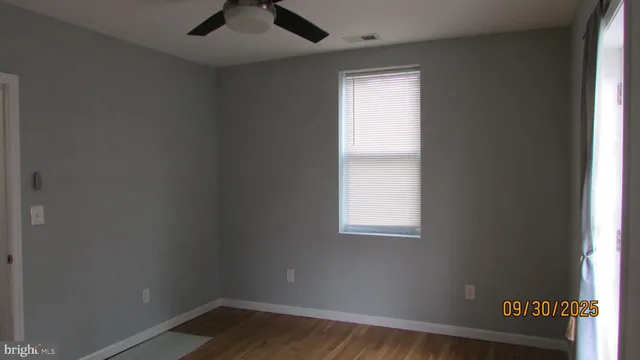 an empty room with wooden floor and closet
