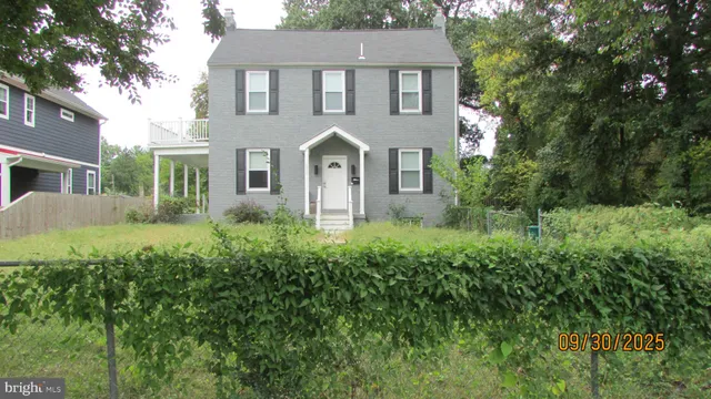 a front view of a house with a yard garage and outdoor seating