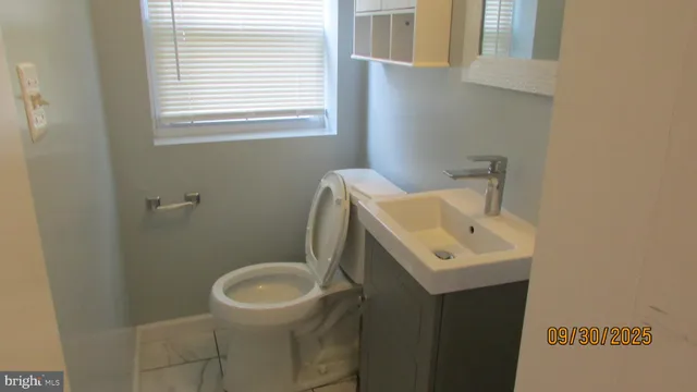 a living room with a fireplace and a window