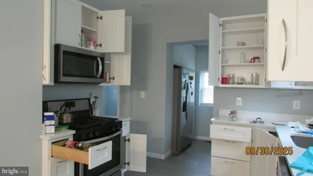 a kitchen with stainless steel appliances a stove a microwave and cabinets