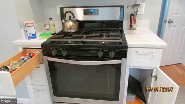 a stove top oven sitting inside of a kitchen
