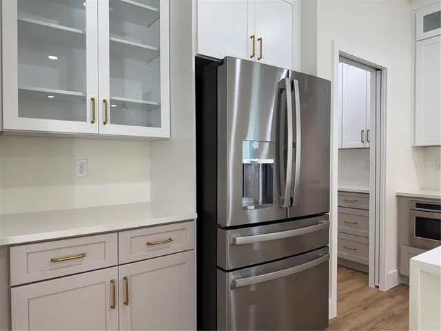a metallic refrigerator freezer sitting in a kitchen