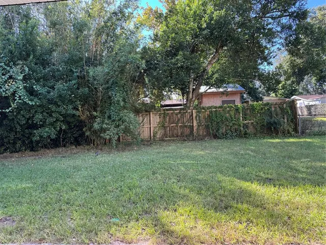 a backyard of a house with lots of green space