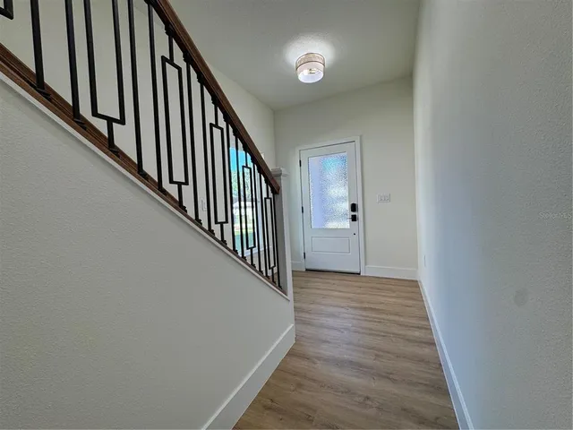 a view of a hallway with wooden floor