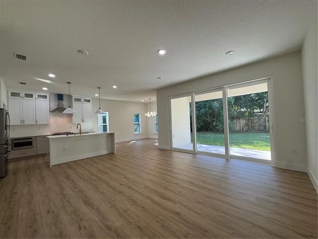 a view of kitchen with cabinets and wooden floor