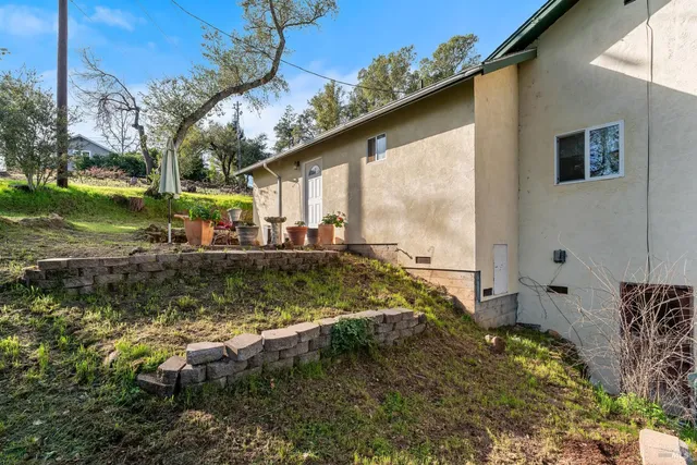 a view of a patio with table and chairs and potted plants