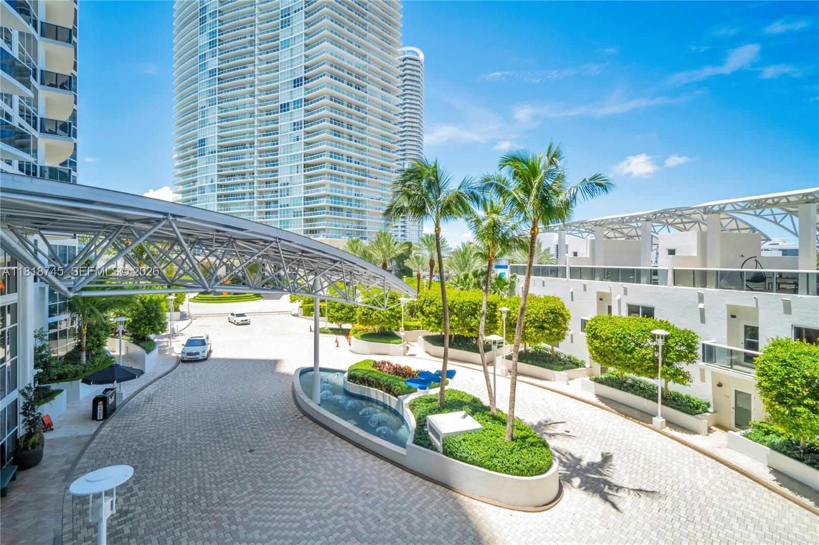 400 Alton Road, Unit 407 Miami Beach, FL 33139 - Photo 45 of 74 407 sits to the side and over water feature which is a beaiutul night scape and valet with is hidden when sitting on the balcony
