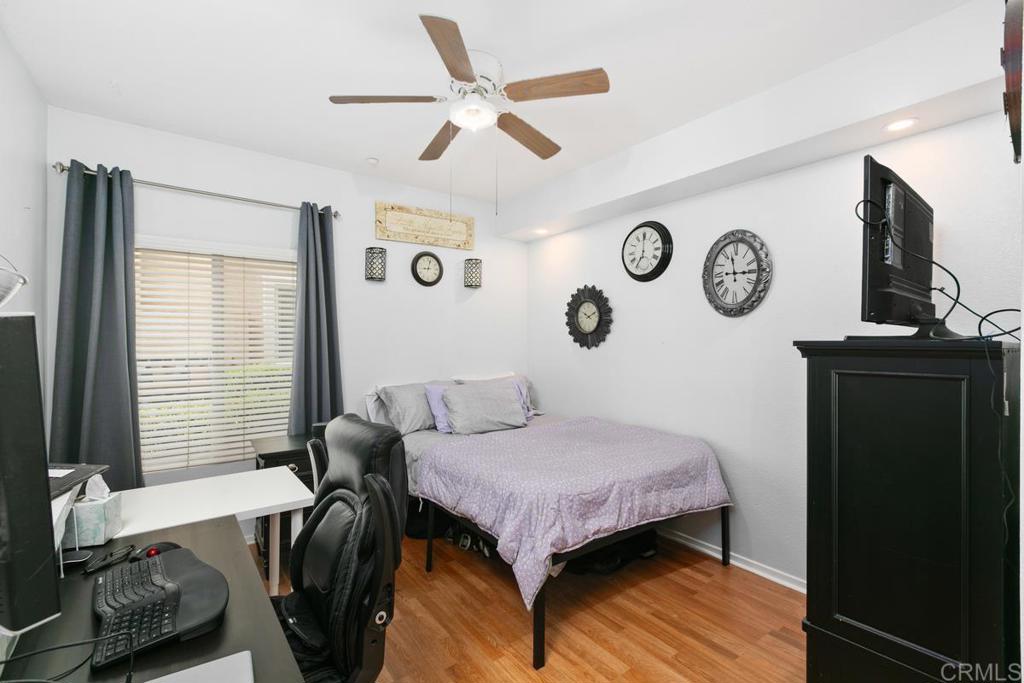 9728 Marilla Drive, Unit 712 Lakeside, CA 92040 - Photo 13 of 25 a bedroom with a bed and a clock on the wall