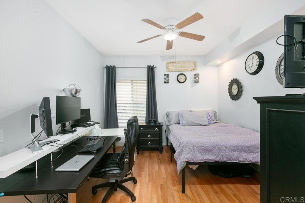 9728 Marilla Drive, Unit 712 Lakeside, CA 92040 - Photo 14 of 25 a bedroom with a bed and a chandelier