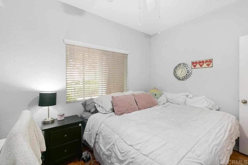 9728 Marilla Drive, Unit 712 Lakeside, CA 92040 - Photo 18 of 25 a bedroom with a bed and a lamp