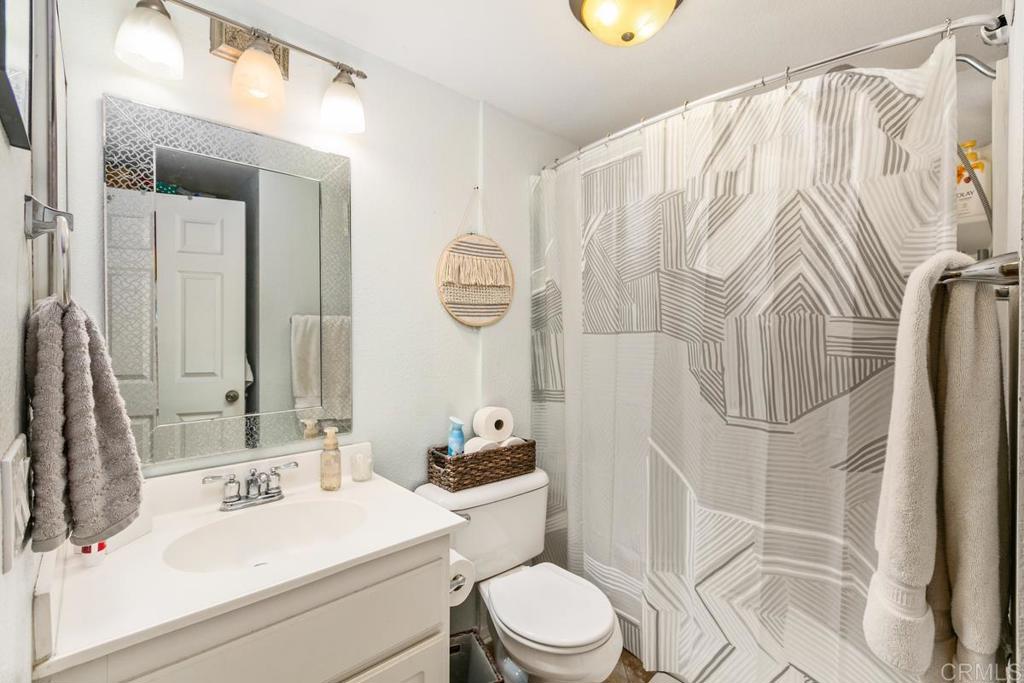9728 Marilla Drive, Unit 712 Lakeside, CA 92040 - Photo 19 of 25 a bathroom with a sink vanity mirror and toilet