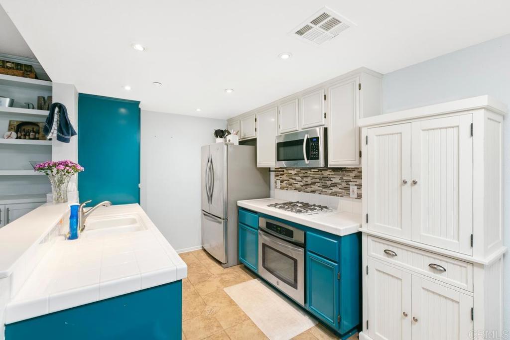 9728 Marilla Drive, Unit 712 Lakeside, CA 92040 - Photo 8 of 25 a kitchen with a sink stove and refrigerator