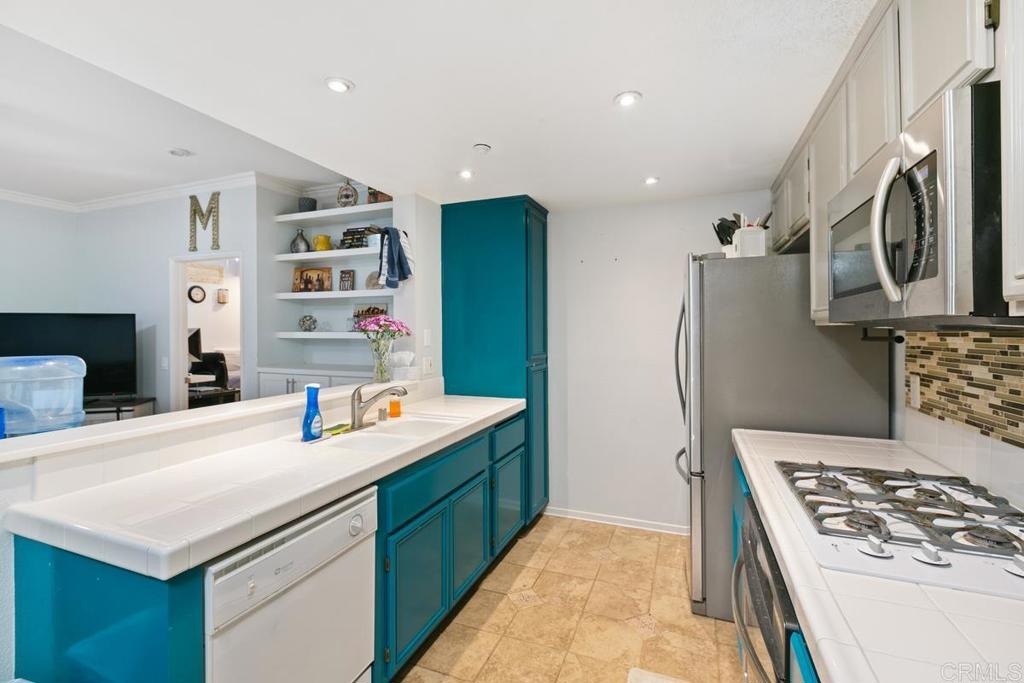 9728 Marilla Drive, Unit 712 Lakeside, CA 92040 - Photo 9 of 25 a kitchen that has a sink a stove and a refrigerator