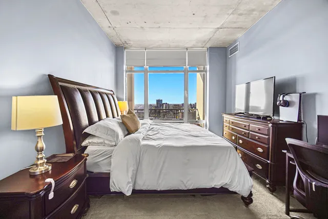 a bedroom with a bed and a window