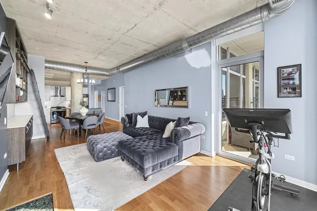 a living room with furniture a wooden floor and a table