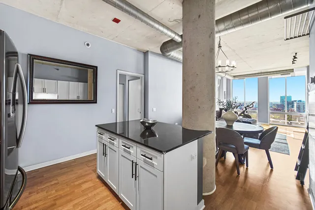 a kitchen with stainless steel appliances granite countertop a sink and a refrigerator