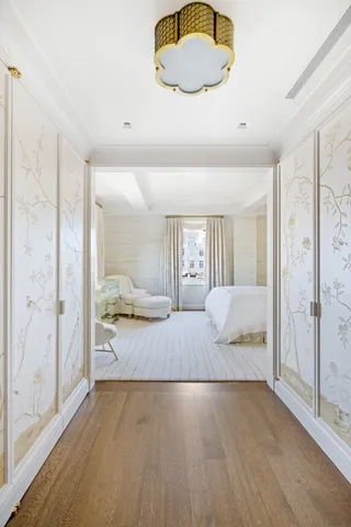 a bedroom with a bed couch and a large window