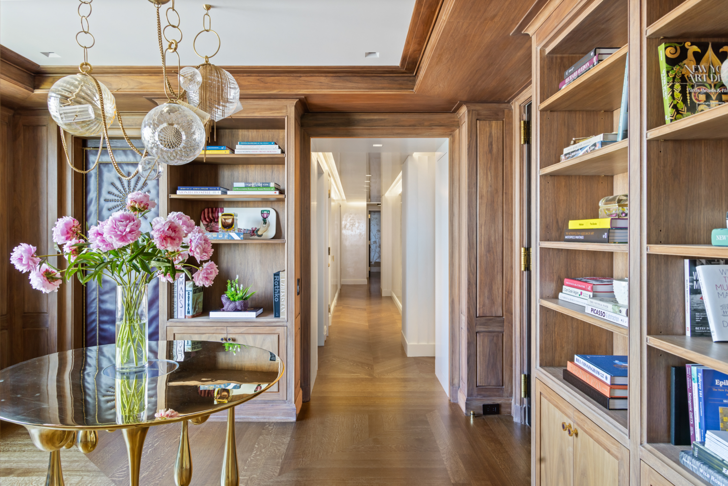 1049 5th Avenue, Unit 19B Manhattan, NY 10028 - Photo 16 of 20 a view of a hallway with wooden floor and a book shelf