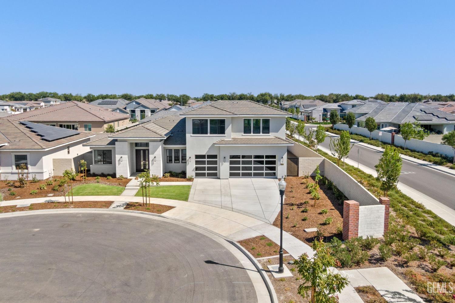an aerial view of a house with a big yard and large trees