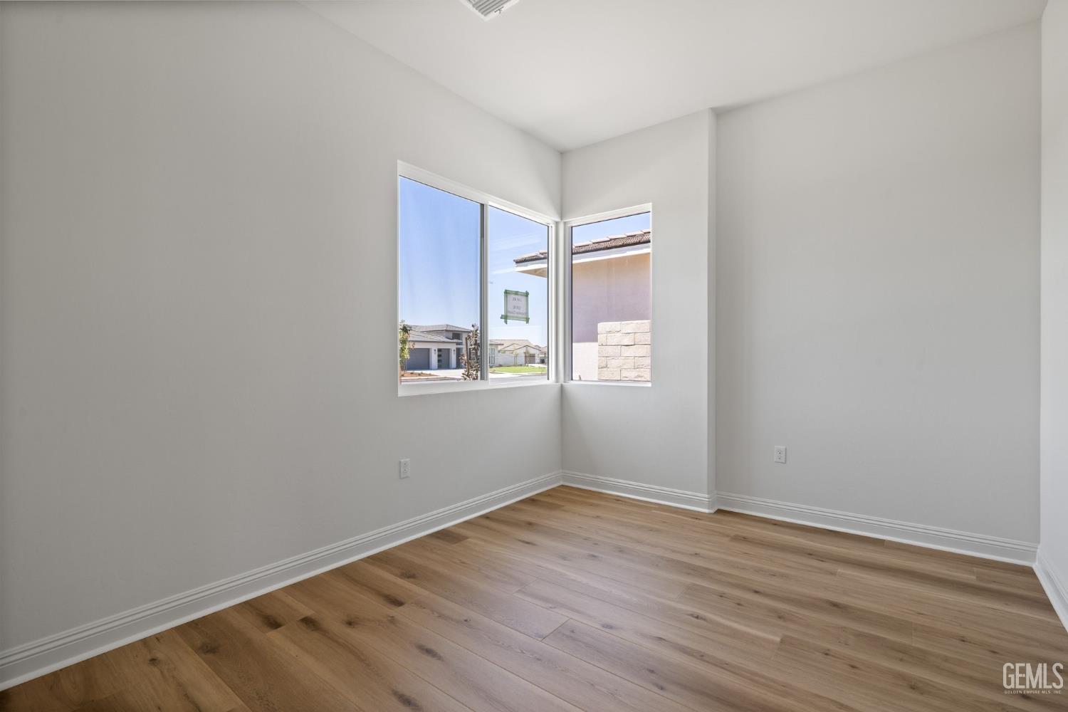 Undisclosed Address Bakersfield, CA 93311 - Photo 11 of 71 a view of a room with wooden floor and windows in it