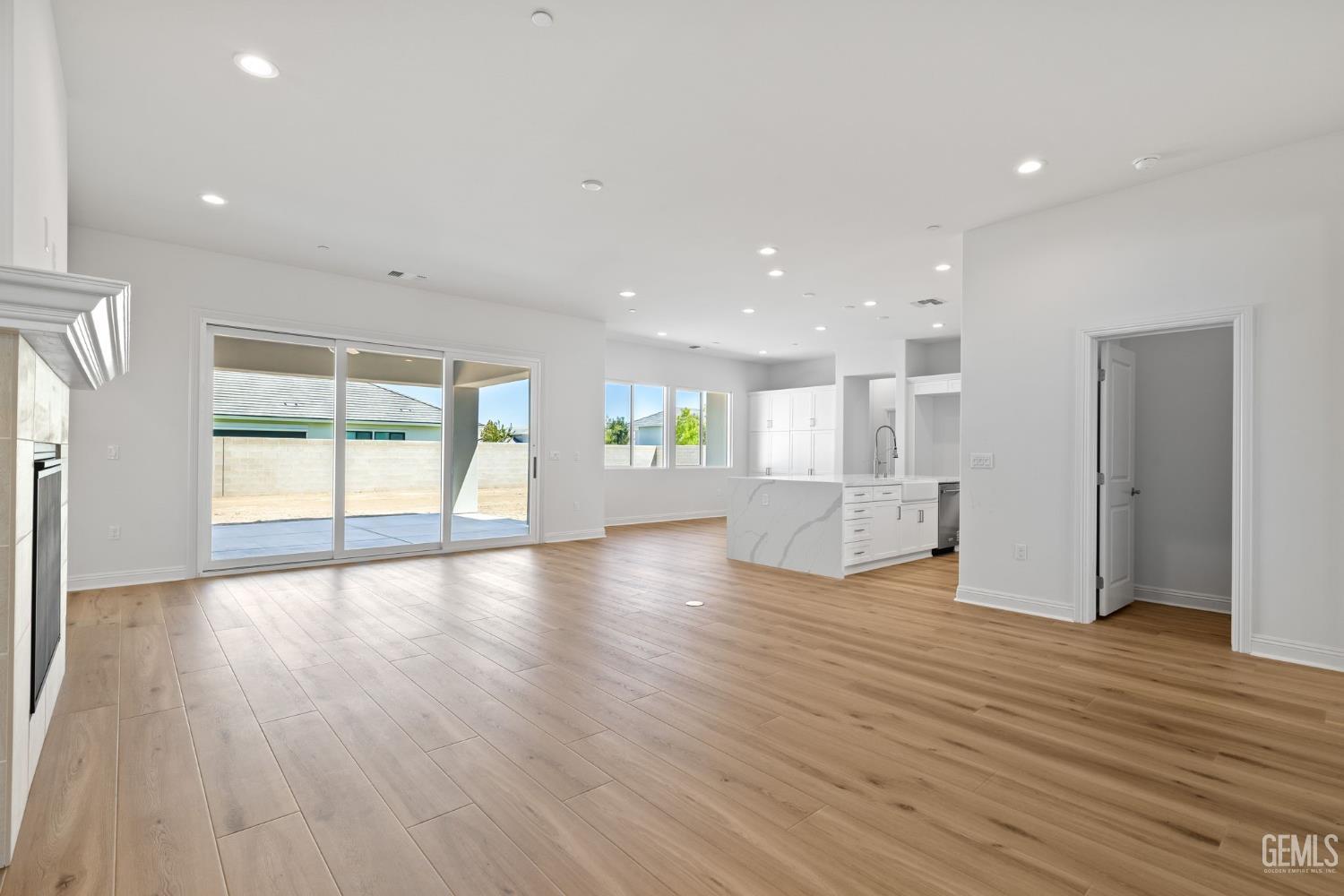Undisclosed Address Bakersfield, CA 93311 - Photo 13 of 71 a view of an empty room with wooden floor and a window