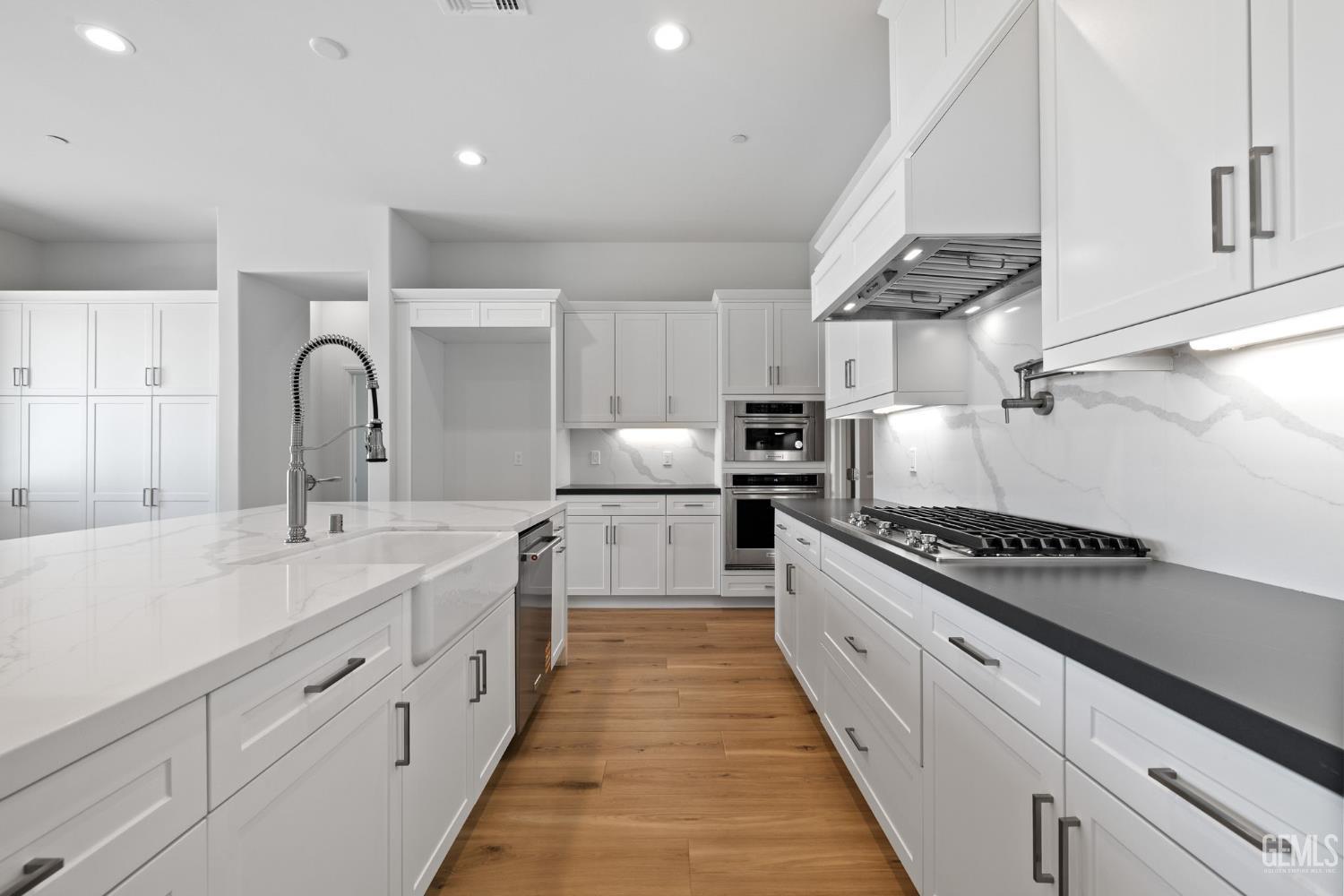 Undisclosed Address Bakersfield, CA 93311 - Photo 20 of 71 a large kitchen with stainless steel appliances granite countertop a lot of cabinets and stove