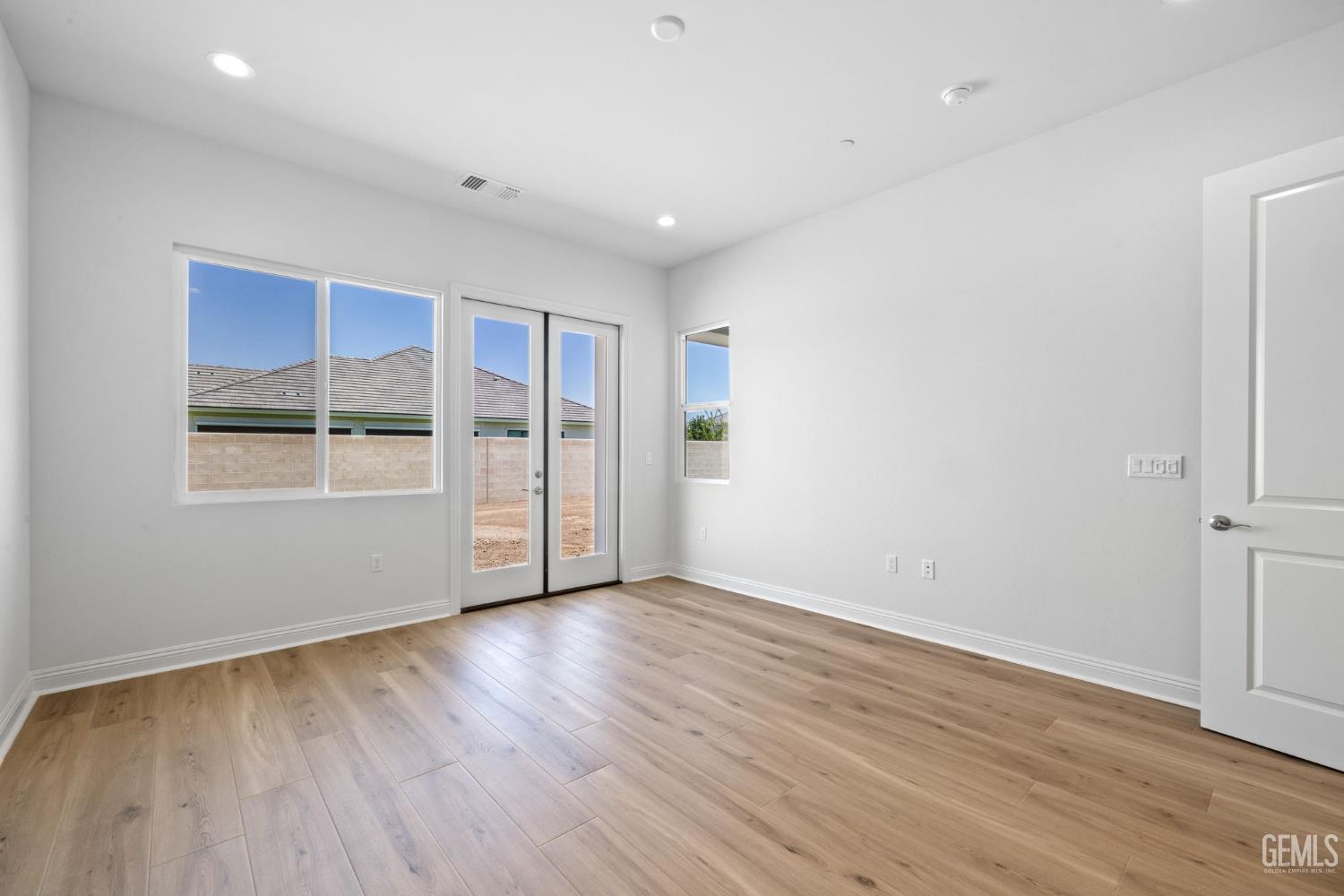Undisclosed Address Bakersfield, CA 93311 - Photo 28 of 71 a view of an empty room with wooden floor and windows