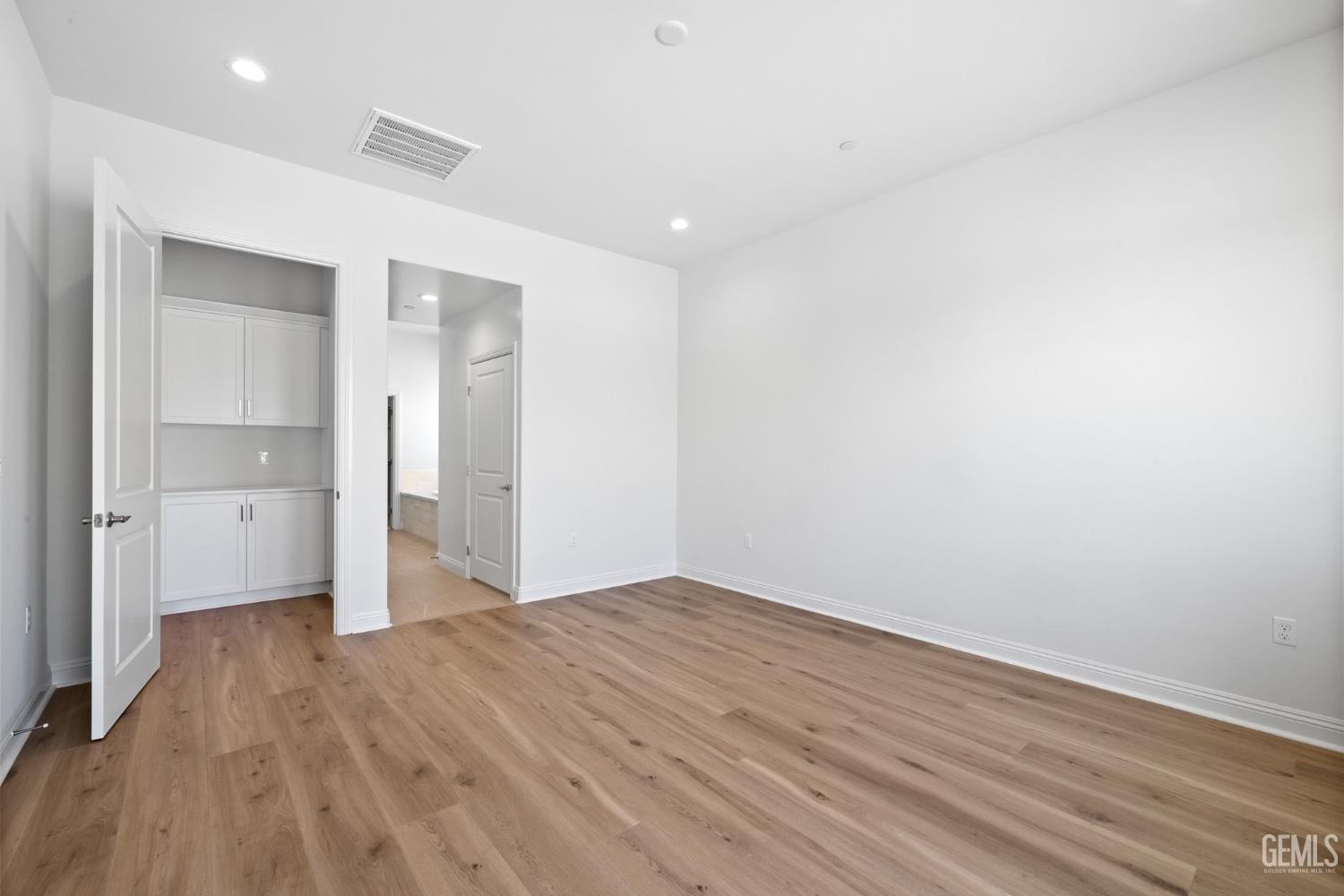 Undisclosed Address Bakersfield, CA 93311 - Photo 30 of 71 a view of empty room with wooden floor