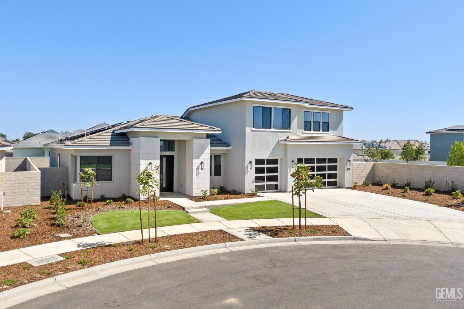Undisclosed Address Bakersfield, CA 93311 - Photo 3 of 71 a front view of a house with a garden and plants