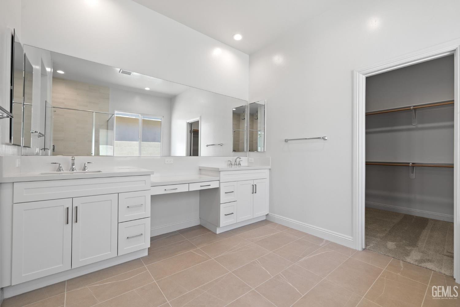 Undisclosed Address Bakersfield, CA 93311 - Photo 31 of 71 a spacious bathroom with a granite countertop sink mirror and double
