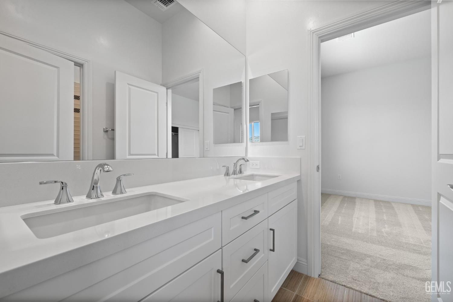 Undisclosed Address Bakersfield, CA 93311 - Photo 37 of 71 a bathroom with double sink and a mirror