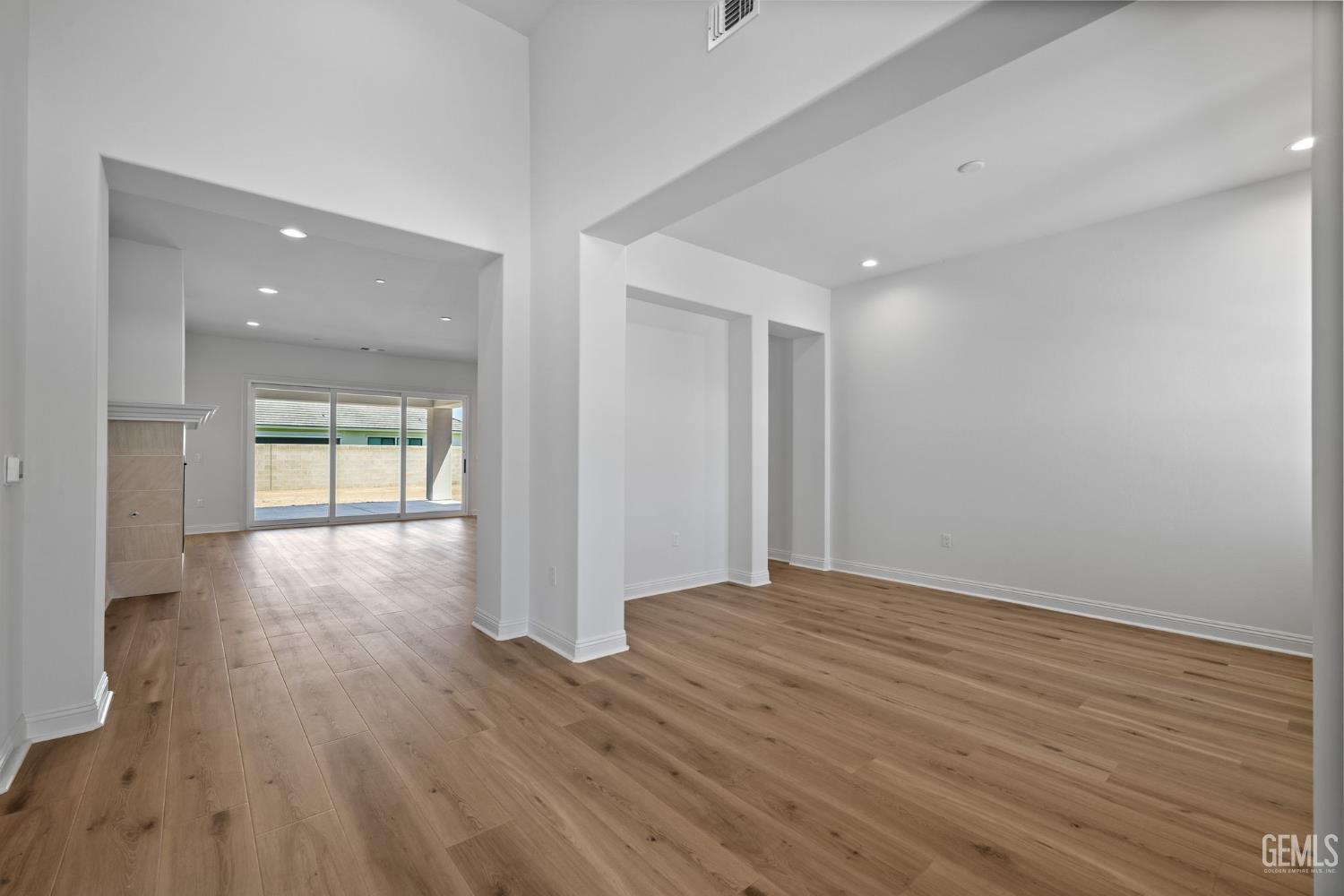 Undisclosed Address Bakersfield, CA 93311 - Photo 7 of 71 a view of an empty room with wooden floor and a window