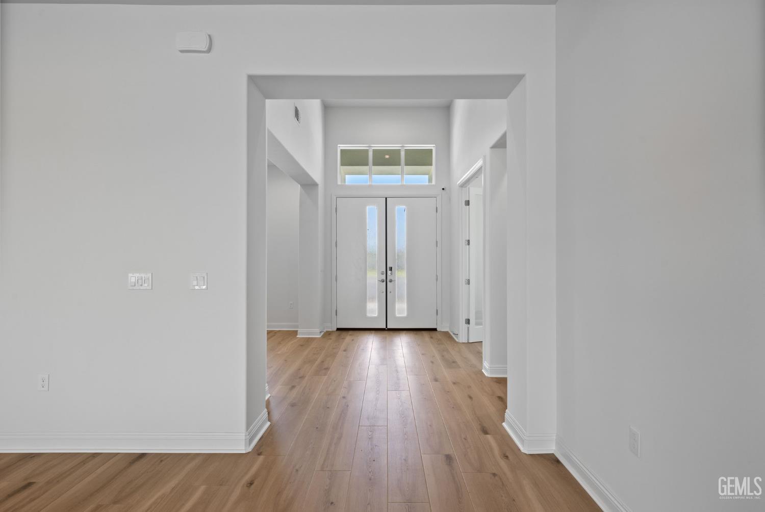 Undisclosed Address Bakersfield, CA 93311 - Photo 8 of 71 a view of an empty room with wooden floor and a window