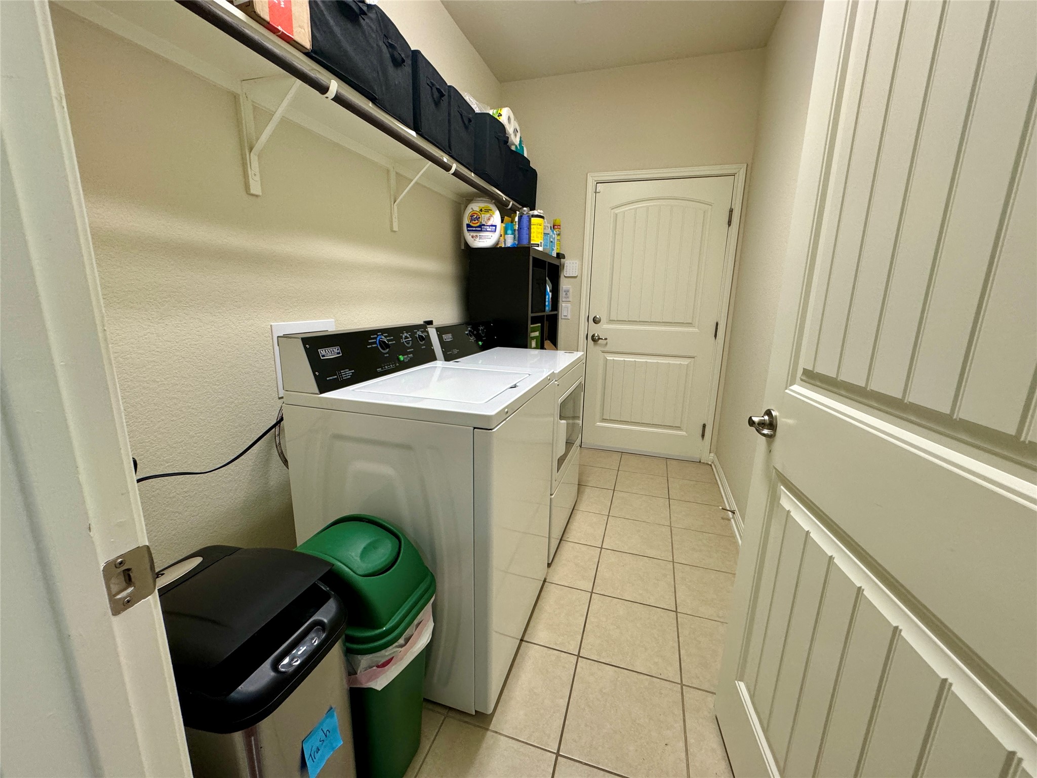 5904 Baythorne Drive Austin, TX 78747 - Photo 12 of 24 Laundry room featuring light tile flooring and independent washer and dryer