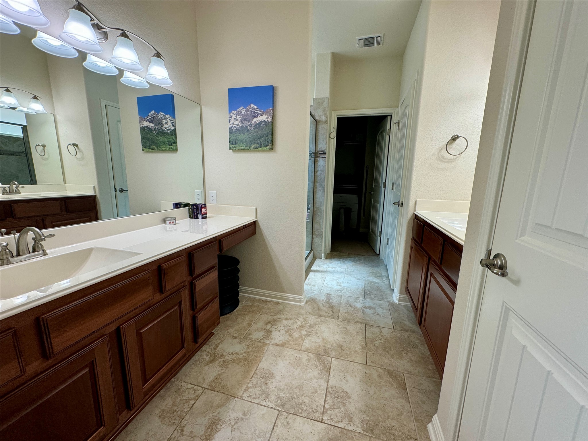 5904 Baythorne Drive Austin, TX 78747 - Photo 13 of 24 Full bathroom featuring two vanities and a shower stall