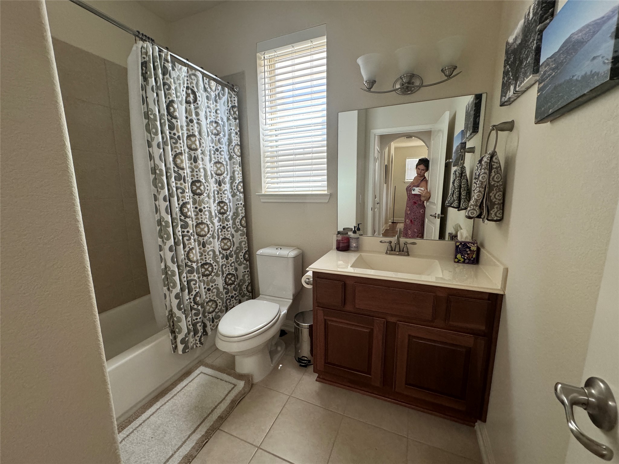 5904 Baythorne Drive Austin, TX 78747 - Photo 23 of 24 Bathroom featuring vanity, shower / tub combo with curtain, and light tile patterned flooring
