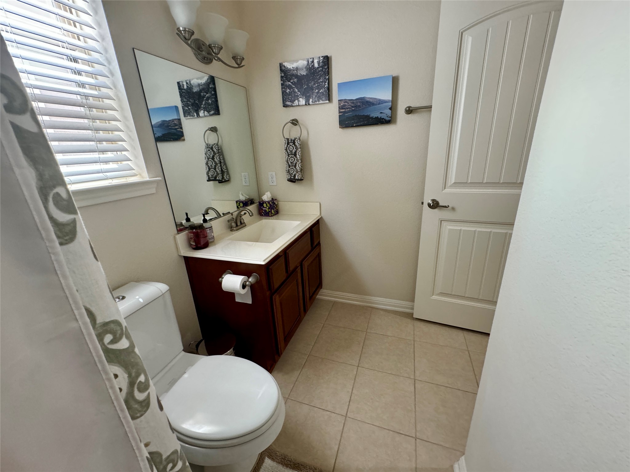 5904 Baythorne Drive Austin, TX 78747 - Photo 24 of 24 Half bath with vanity and light tile patterned floors
