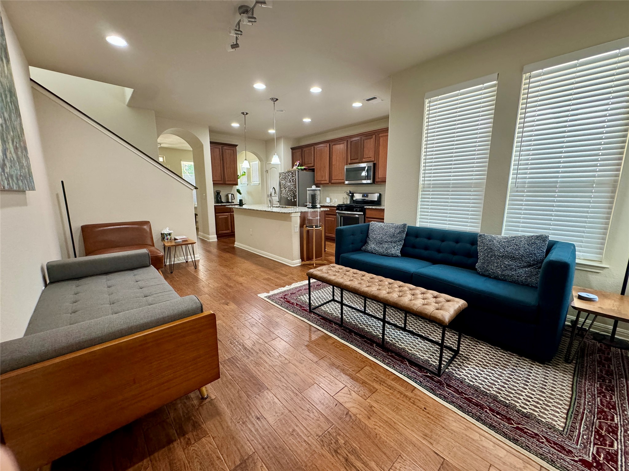 5904 Baythorne Drive Austin, TX 78747 - Photo 10 of 24 Living room with arched walkways, recessed lighting, and dark wood finished floors