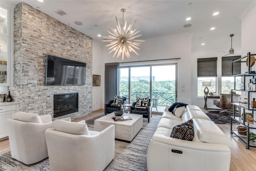 a living room with furniture fireplace and flat screen tv