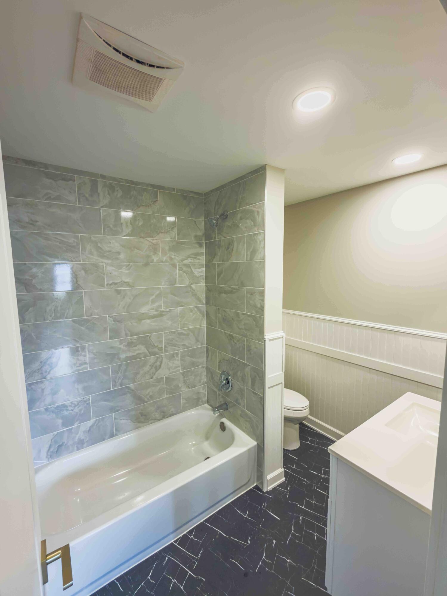 5836 Sloan Street Portage, IN 46368 - Photo 8 of 17 a bathroom with a bathtub and a toilet