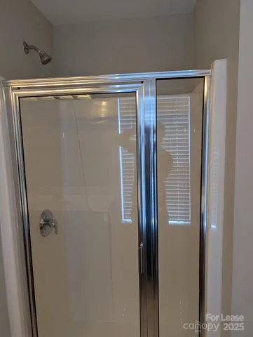 a bathroom with a glass shower door