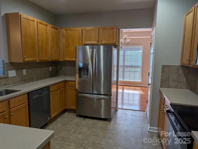 a kitchen with a refrigerator and a sink