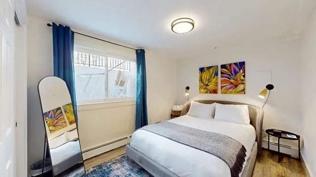 a bedroom with a bed and a window