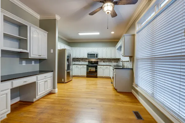 a kitchen with stainless steel appliances granite countertop a sink and cabinets