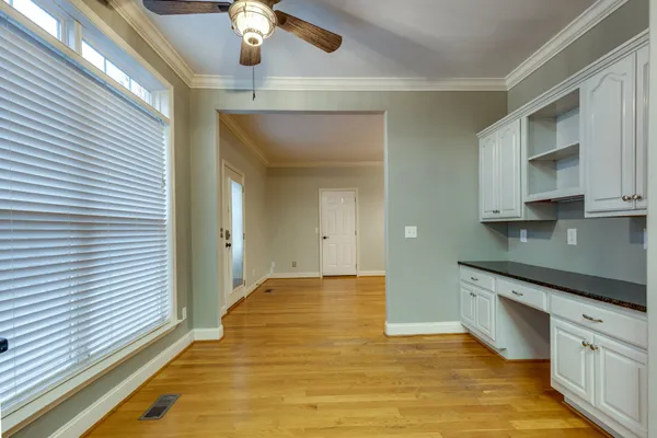 a view of a kitchen with a sink and cabinets