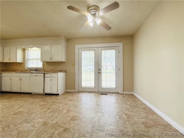 a view of a kitchen with a sink and a window