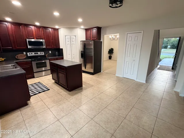a kitchen with stainless steel appliances a refrigerator and a sink
