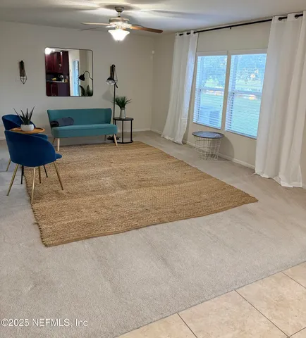 a living room with a couch and a large window