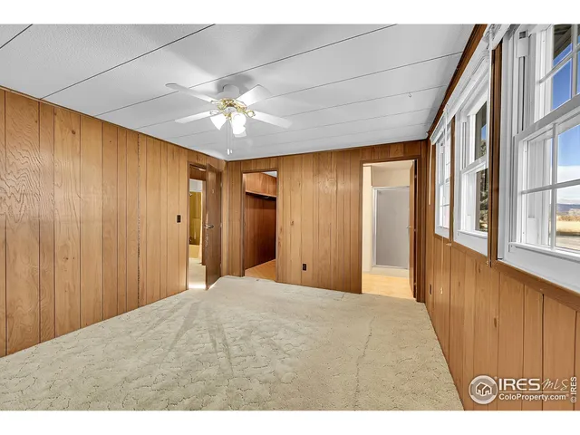 a view of a hallway with a chandelier fan