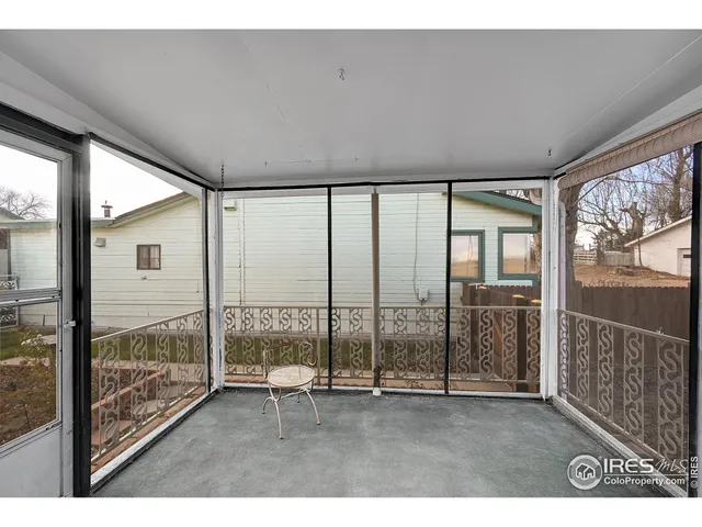 a view of an empty room and wooden floor